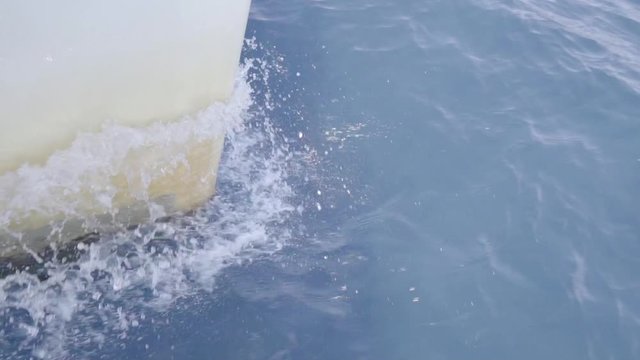 slow motion detail bow of sailing boat in water