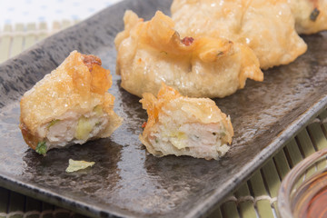 fried pork gyoza dumplings on black plate