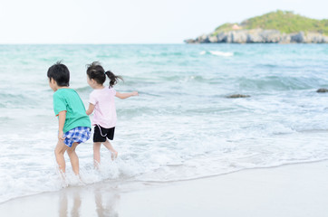 Young little girl and boy on the beach