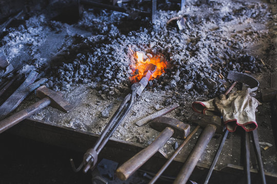 Iron bar heating up in the fire in a workshop