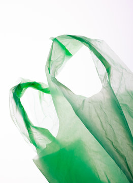 Green plastic bag isolated on white.