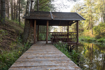 gazebo with fireplace on the bank of the stream