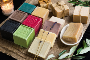 Various colored olive oil soaps on sackcloth