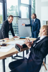 businessmen talking in office