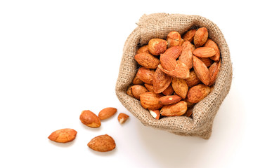 Almond nuts in the shell In sackcloth on a white background