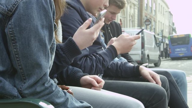 Close Up Of Teenage Friends Using Mobile Phones Shot On R3D