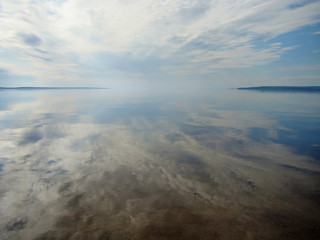 Onega lake with the reflection of the sky, Karelia, Russian North, Russia