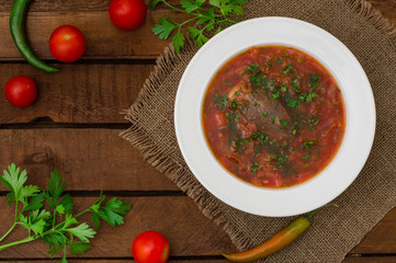Vegetable borscht. Traditional Ukrainian and Russian soup. Wooden background. Close-up. Top view