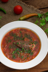 Vegetable borscht. Traditional Ukrainian and Russian soup. Wooden background. Close-up. Top view