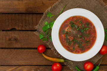 Vegetable borscht. Traditional Ukrainian and Russian soup. Wooden background. Close-up. Top view