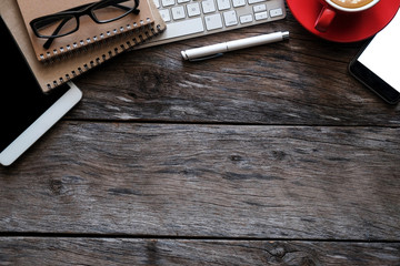 office stuff with tablet, laptop ,smartphone and coffee cup notepad top view shot.
