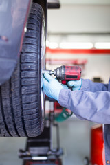 Auto mechanic repairing car. 