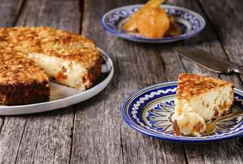 Rice pie cake with dried fruit on a vintage wooden table. Selective focus 