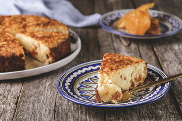 Rice pie cake with dried fruit on a vintage wooden table. Selective focus. Toned image. Haze effect 