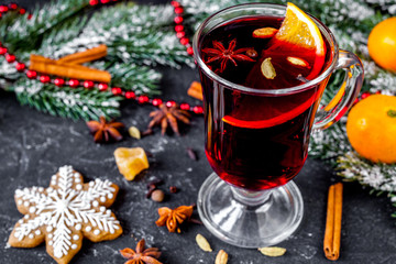 Christmas mulled wine with spices in cup on dark background