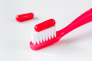 concept toothache with toothbrush and tablet at white background
