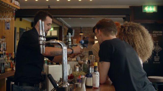 Bartender Giving Cocktail Making Demonstration In Bar