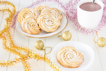 Christmas concept. Round shortbread cookies roses form with icing and Cup hot chocolate. Vintage...