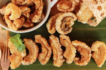 Fried pork skin is delicious on wood background
