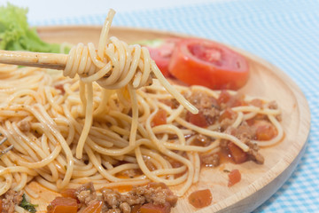 spaghetti with sauce and chopstick