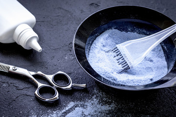 hair dye with brush on dark background