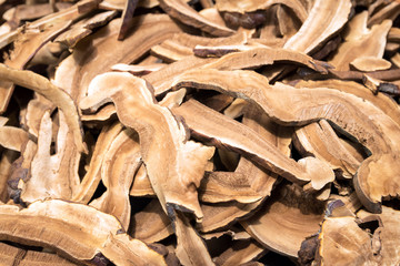 Dry ginseng roots sliced texture and background.