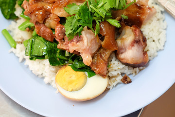 Stewed pork leg with egg and on rice on the table