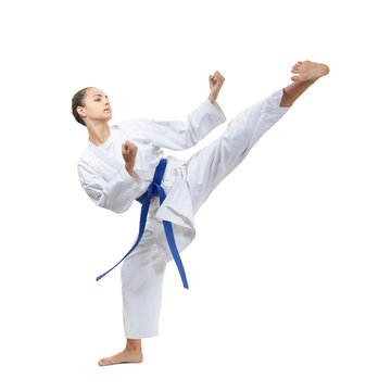 With a blue belt, an adult girl beats a kick