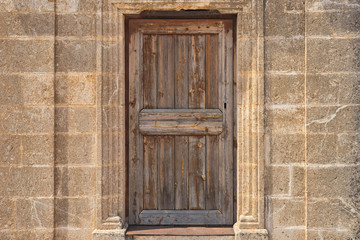 Picture of wooden closed door on the concrete wall