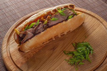 Big sandwich on a wooden kitchen board