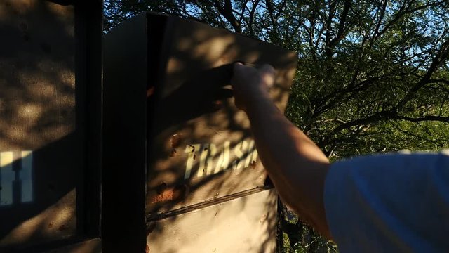 Putting garbage into a Forest Service trash can