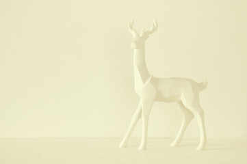 White reindeer on wooden table over white background