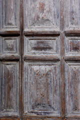 A fragment of an ancient wooden massive door in a medieval building