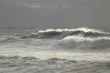 Sea wave against dark sky