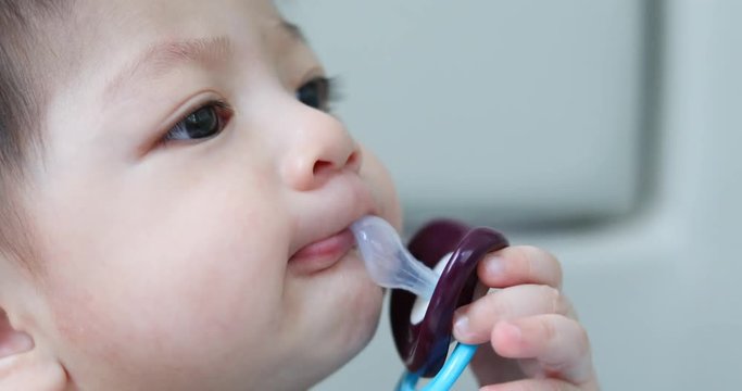 asian kid baby sucking nipple pacifier fancy vampire teeth dracula monster in halloween celebration party