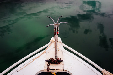 Bow of a small boat with anchor
