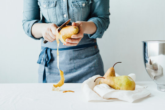 Woman pealing pears
