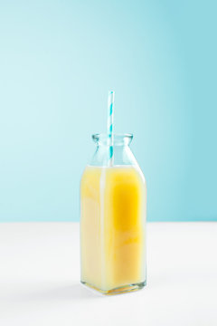 Healthy orange juice on blue background.