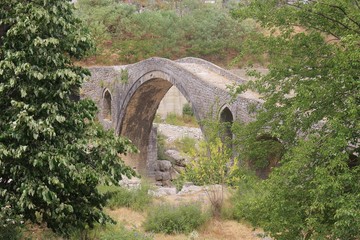 The Mesi bridge in Mes, Albania, near Shkoder. An old stone bridge built by the Ottomans in 1770, now a tourist attraction. North Albania, Southeast Europe.