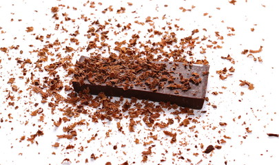 Pile chopped, milled chocolate with shavings isolated on white