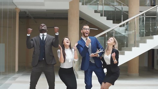 Group confident positive business people celebrate the victory. Slow motion