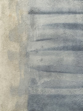 Close up of paint covering graffiti markings on concrete wall