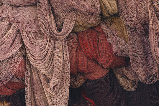 Colorful fish nets hanging in a big pile in Italian fishing village