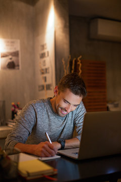 Man writing in his diary at night