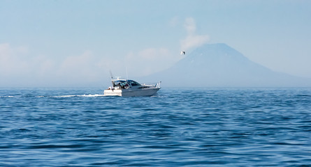 Sport fisher passing front of St Augstine Volcano - 173056802
