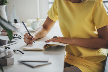 African Woman Writing in a Notebook