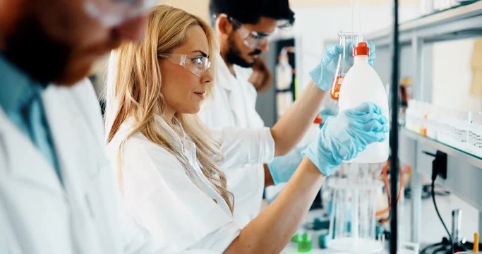 Young students of chemistry working in laboratory