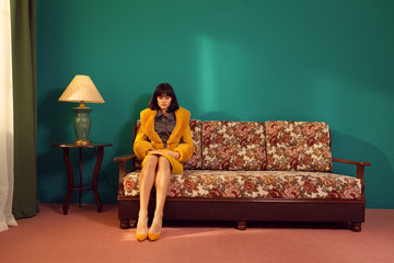 alone lady sitting on a retro couch