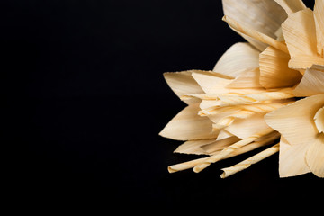 Kind of wood flower isolated on black background; to be placed on the site of cremation in...