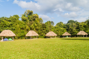 Fototapeta na wymiar Huts in the camping place near Tikal ruins, Guatemala